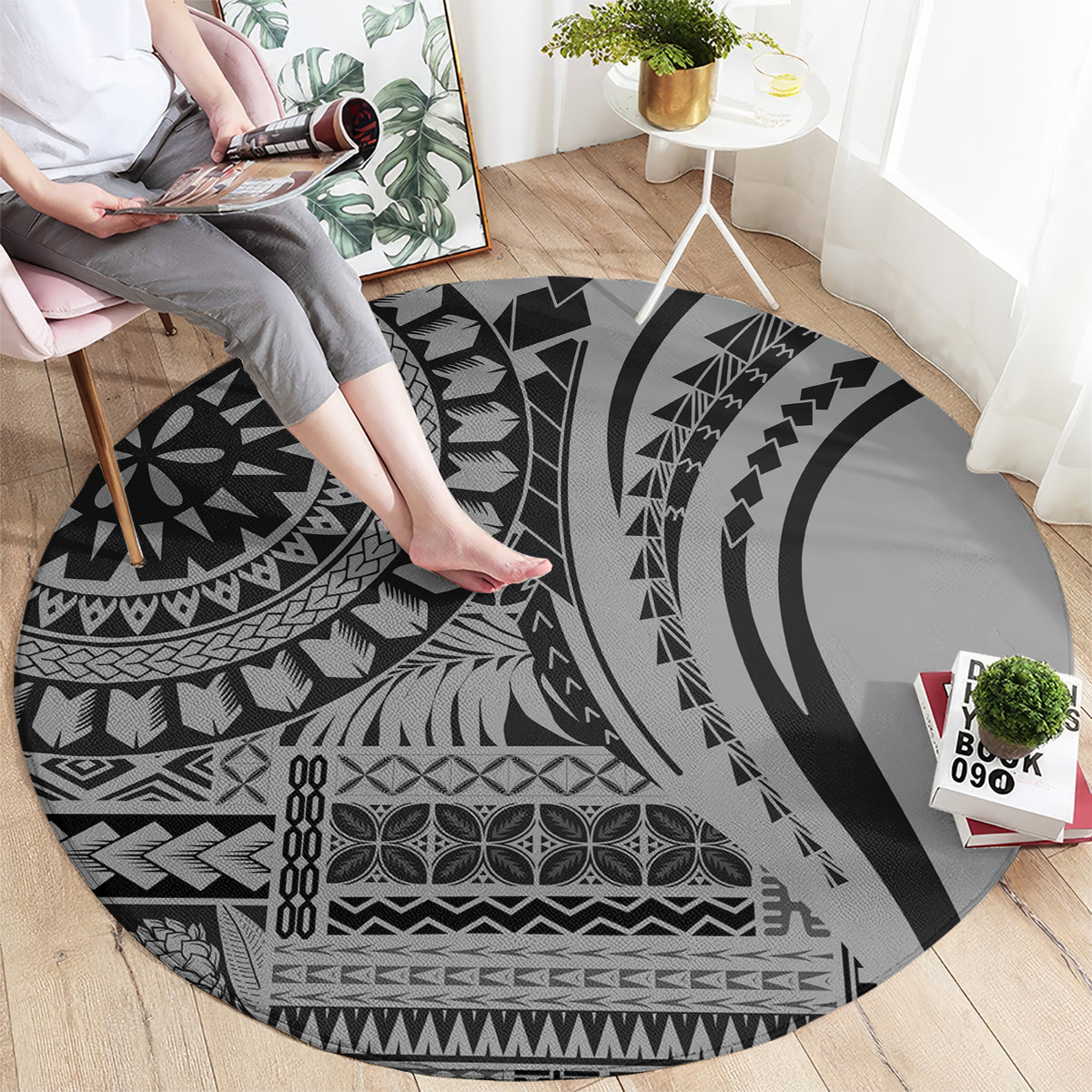Round black tribal patterned rug with large concentric shapes