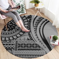 Round black tribal patterned rug with large concentric shapes