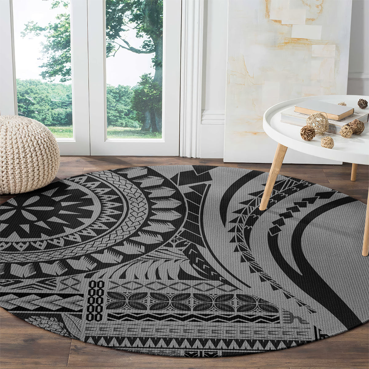 Round black and gray tribal patterned rug on hardwood floor