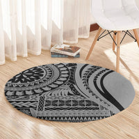Round black and gray tribal patterned area rug on hardwood floor