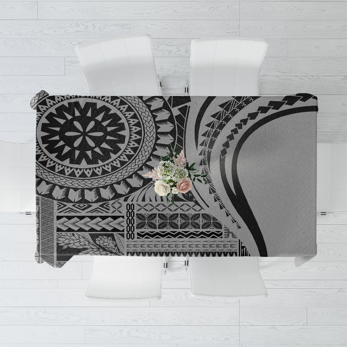 Black patterned art tablecloth with circular motifs and geometric borders, folded on display
