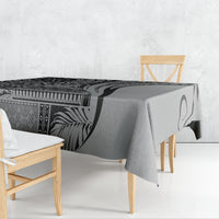 Black and gray patterned art tablecloth draped over rectangular table with chair covers