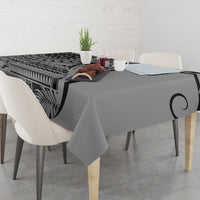 Black art tablecloth with leaf and tribal geometric print, draped over dining table