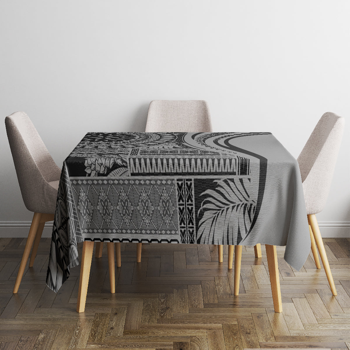 Black patterned art tablecloth with bold swirl and geometric bands, on dining table