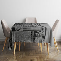 Black patterned art tablecloth with bold swirl and geometric bands, on dining table