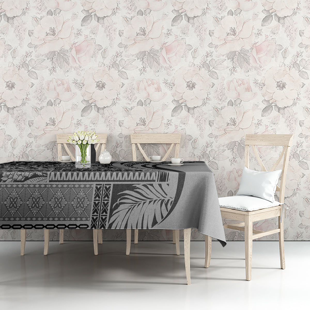 Black and gray patterned art tablecloth on dining table with chair and floral wall decor
