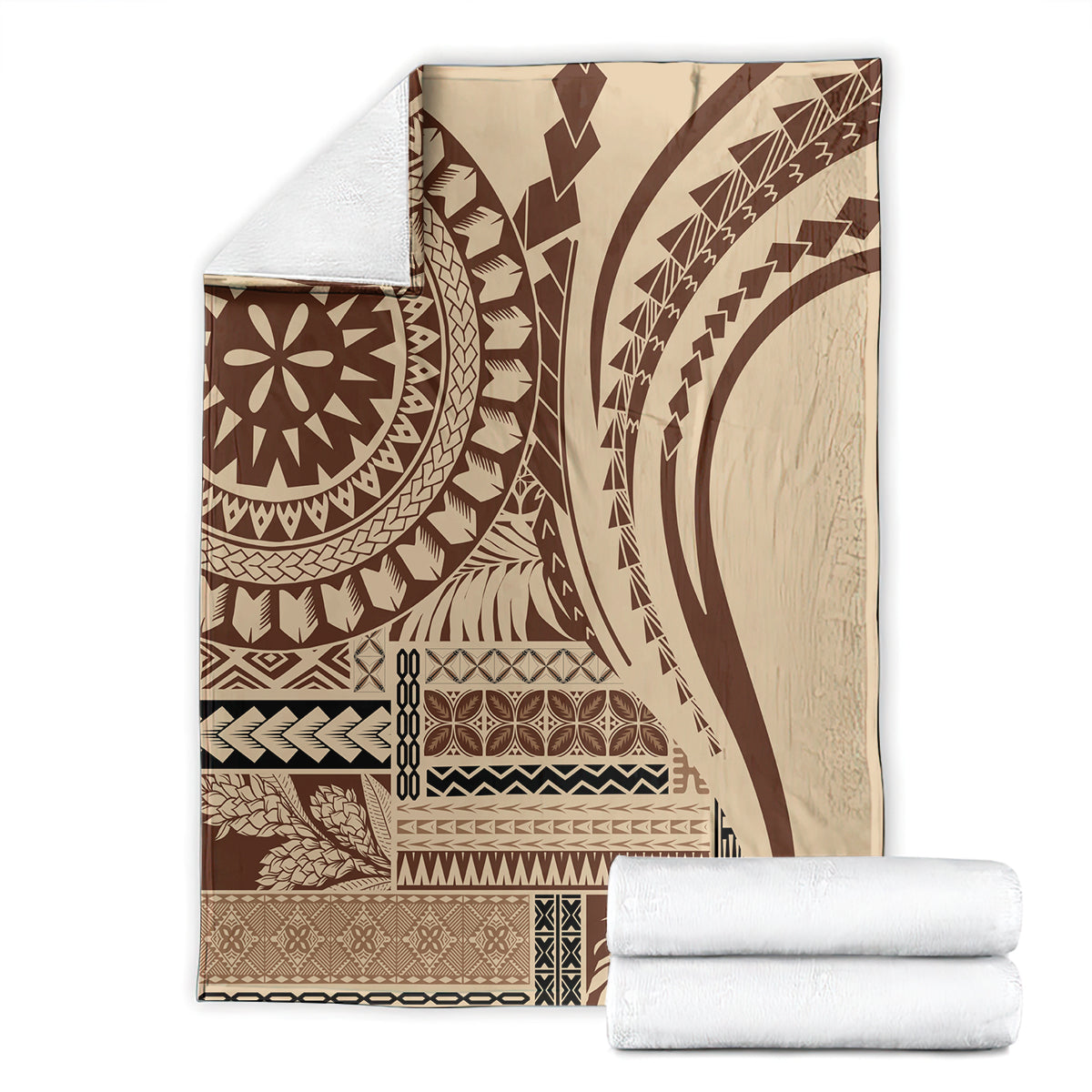 Folded brown and cream geometric art blanket with circular medallion, stacked with white towels