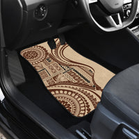 Brown patterned car floor mat on rear driver side footwell