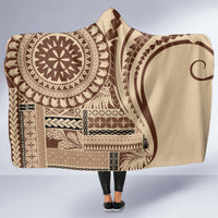 Brown hooded blanket with bold tan and dark geometric artwork, cape-style hood