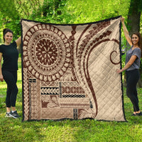 Brown Samoa Siapo-style quilt with large sun medallion and geometric border, laid on grass