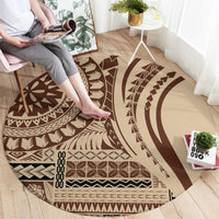 Brown round siapo-style carpet with bold geometric motifs and dark-and-cream sections.