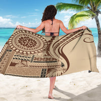Brown and cream geometric patterned sarong with large emblem circle, draped over shoulders