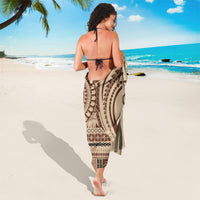Brown and cream patterned sarong, wrapped skirt style with geometric border