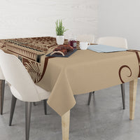Brown and tan patterned tablecloth with swirling leaf and geometric bands, rectangular