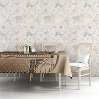 Brown and tan siapo-style tablecloth with geometric border and leaf motifs on table