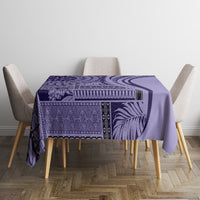 Purple patterned tablecloth on dining table with four upholstered chairs