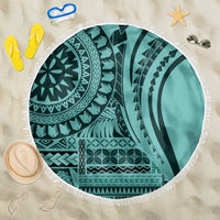 Round turquoise patterned beach blanket with white fringe edge