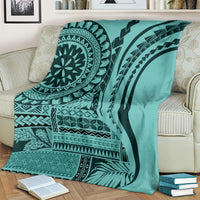 Turquoise patterned throw blanket on sofa with black circular mandala and stripe motifs