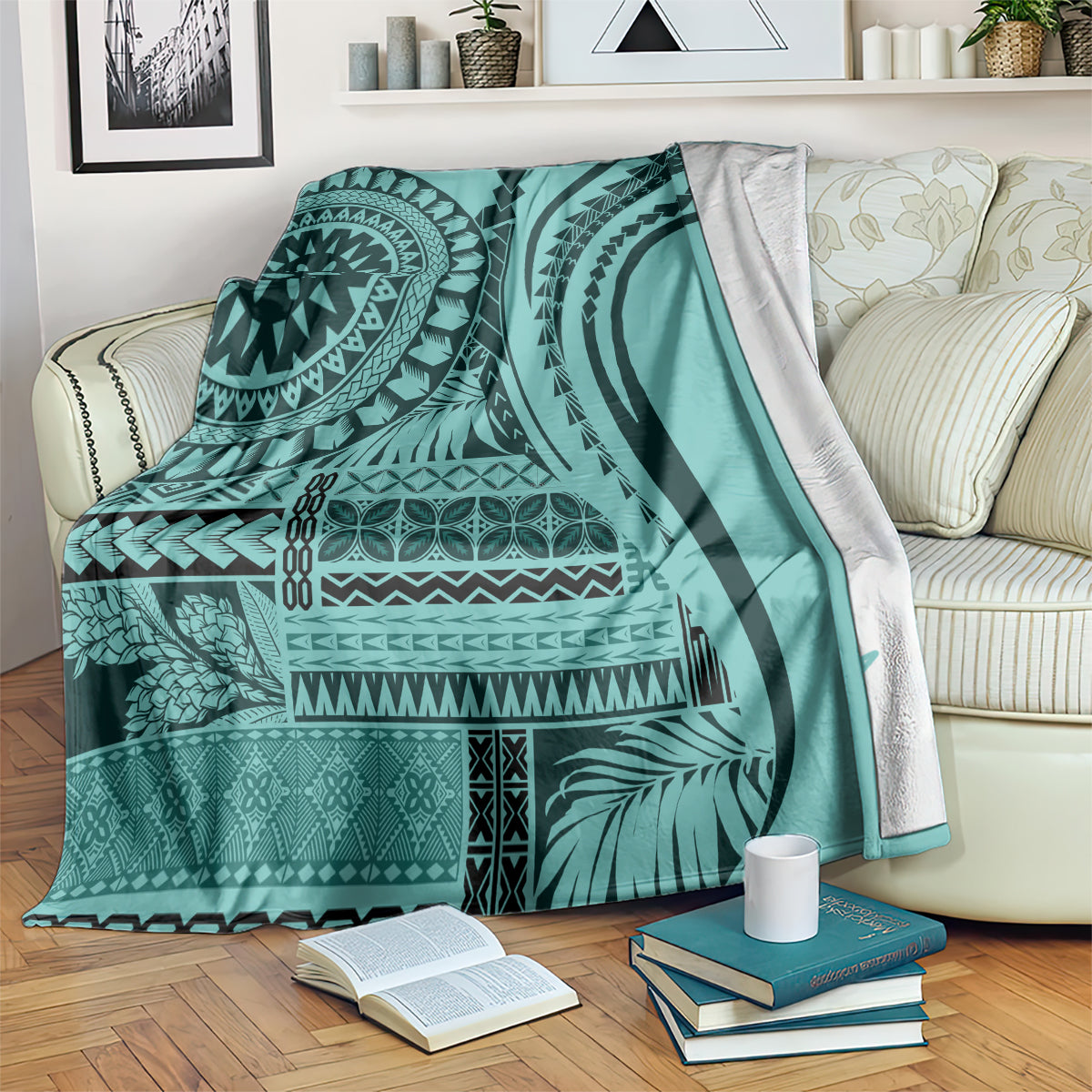 Turquoise patterned blanket spread on couch with black mandala and leaf designs