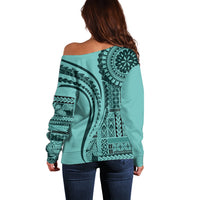 Turquoise off-shoulder sweater, back view with large circular geometric prints