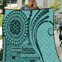 Turquoise quilt with bold circular mandala and tribal stripe patterns, quilted texture