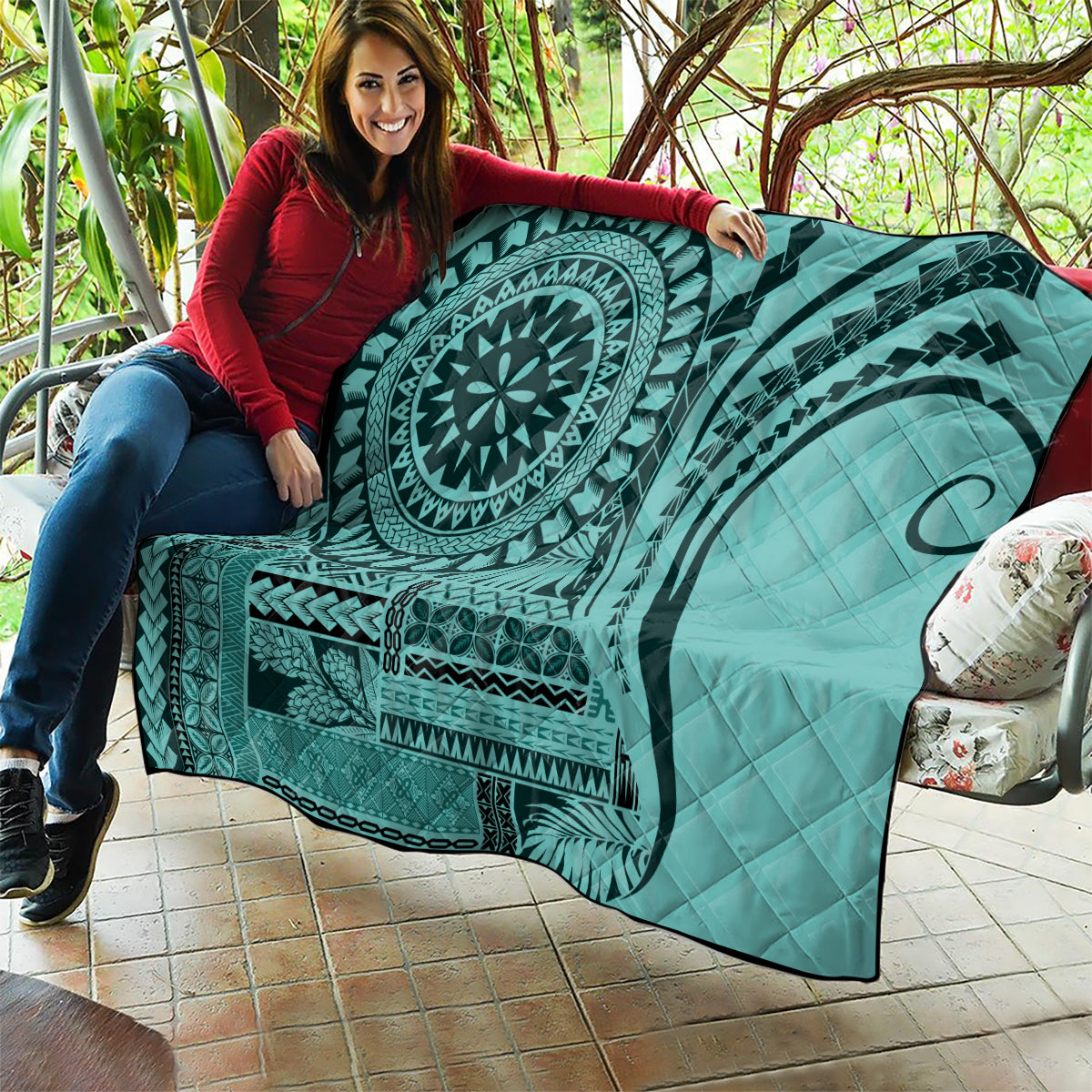 Turquoise quilt blanket with large medallion and crescent swirl motifs, quilted texture