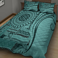Turquoise quilt bed set with circular mandala artwork, patterned edges, and two pillows