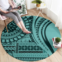 Round turquoise geometric carpet with dark teal circular, zigzag, and wave motifs