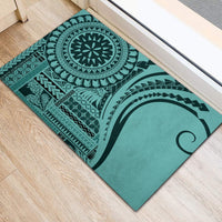 Turquoise rubber doormat with centered circular medallion and geometric border patterns