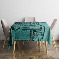 Turquoise patterned tablecloth with leaf stripe motif and geometric border, on dining table