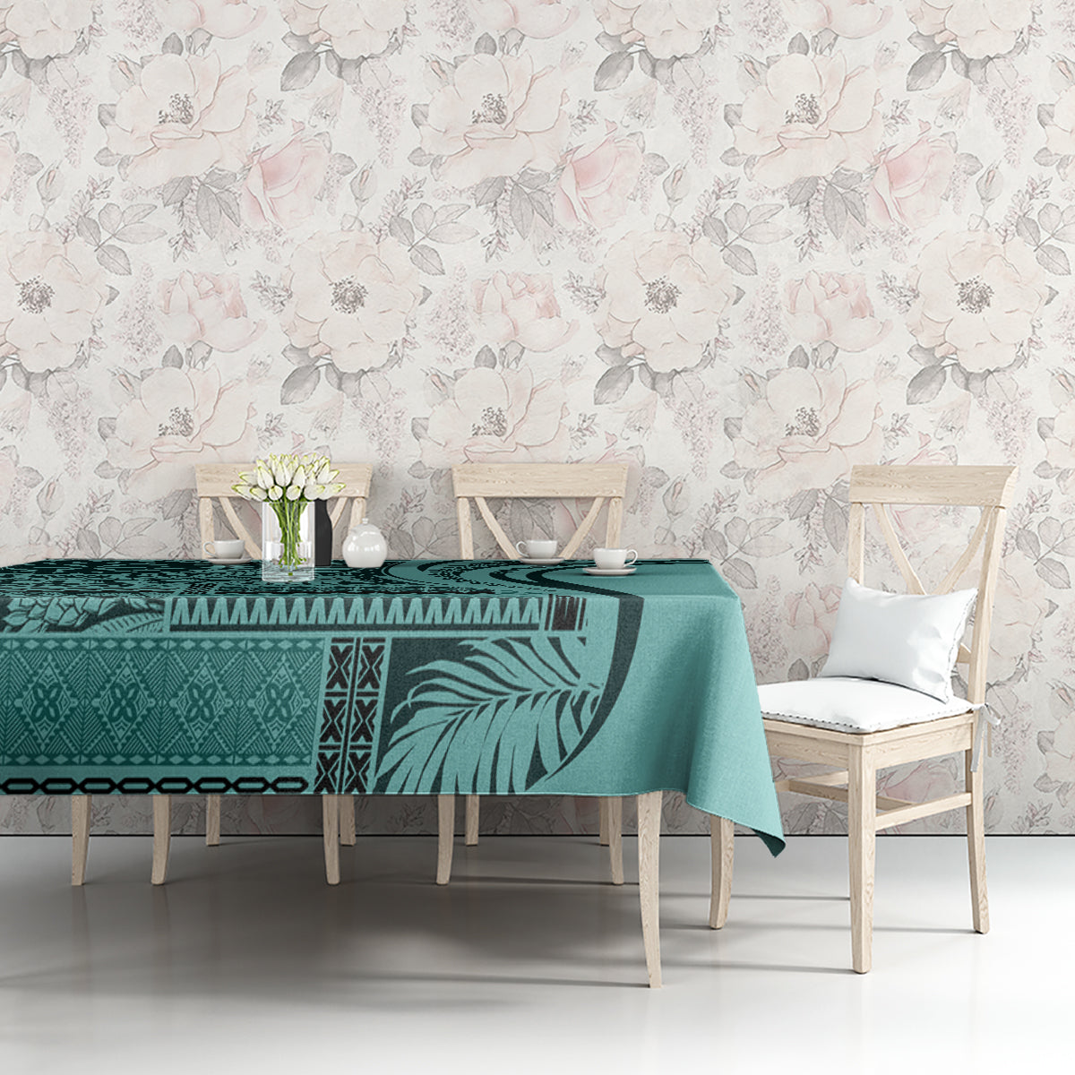 Turquoise tablecloth with leaf and tribal motifs, styled on a dining table with chairs