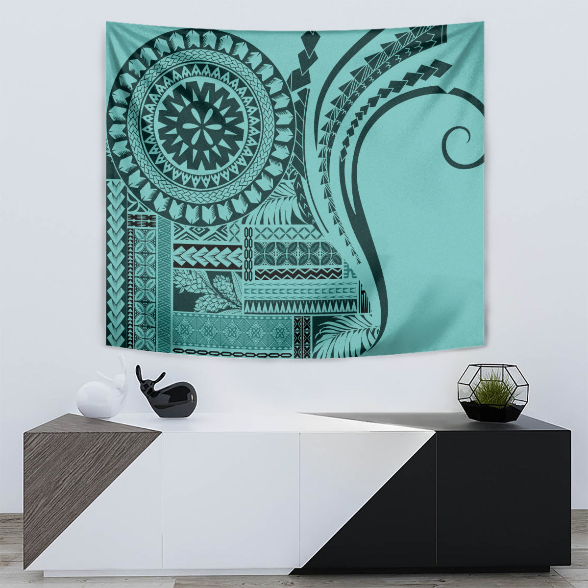 Turquoise Samoan siapo tapestry featuring circular emblem, curving linework, and patterned bands.