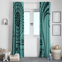 Turquoise window curtain pair framing double doors, with mandala print and dark geometric border