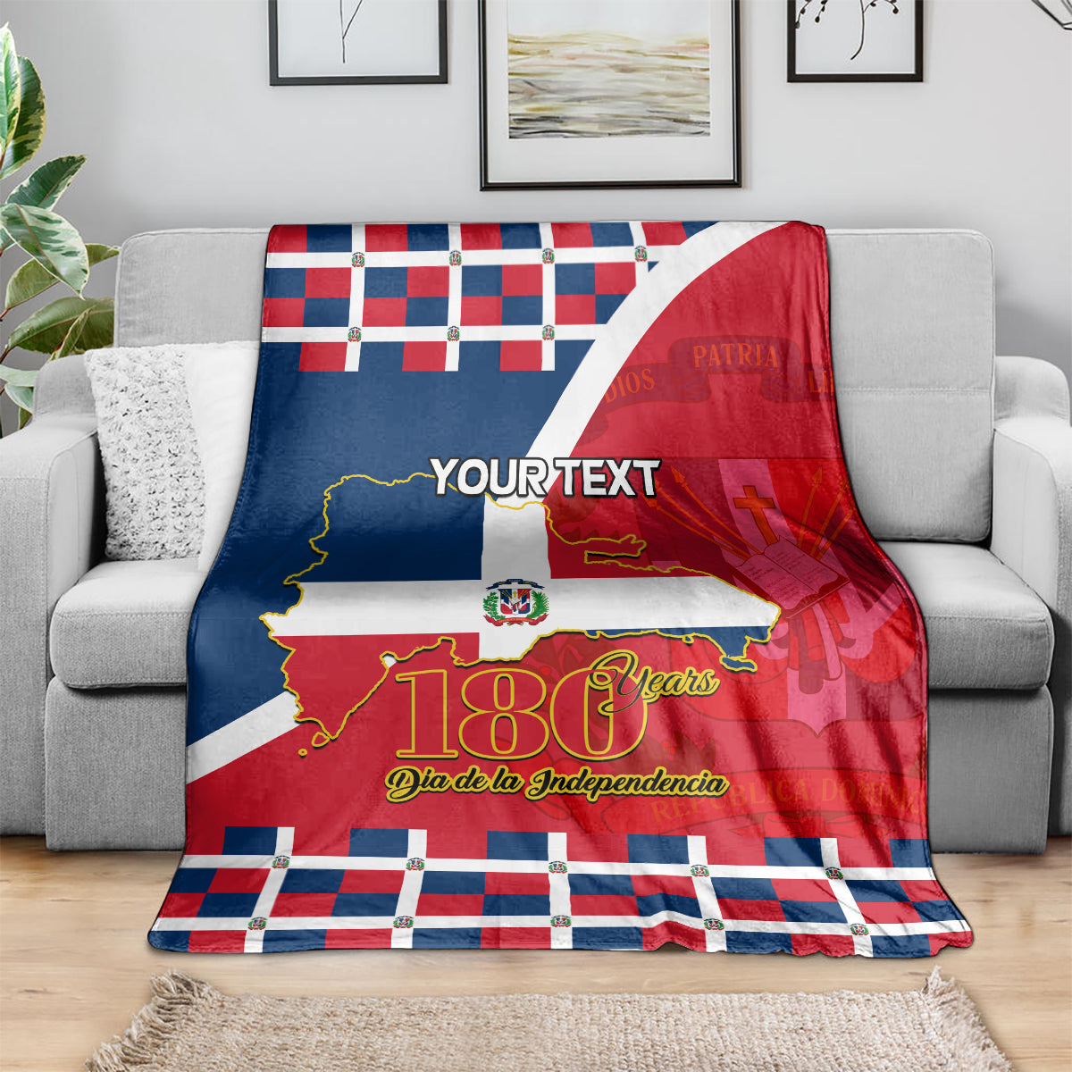 Personalized blanket on gray couch; red, blue, white flag pattern with 180 Years.