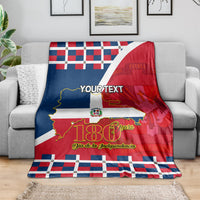 Personalized blanket on gray couch; red, blue, white flag pattern with 180 Years.