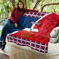 Personalized quilt held outdoors, featuring Dominican flag, 180th years design, plaid edge