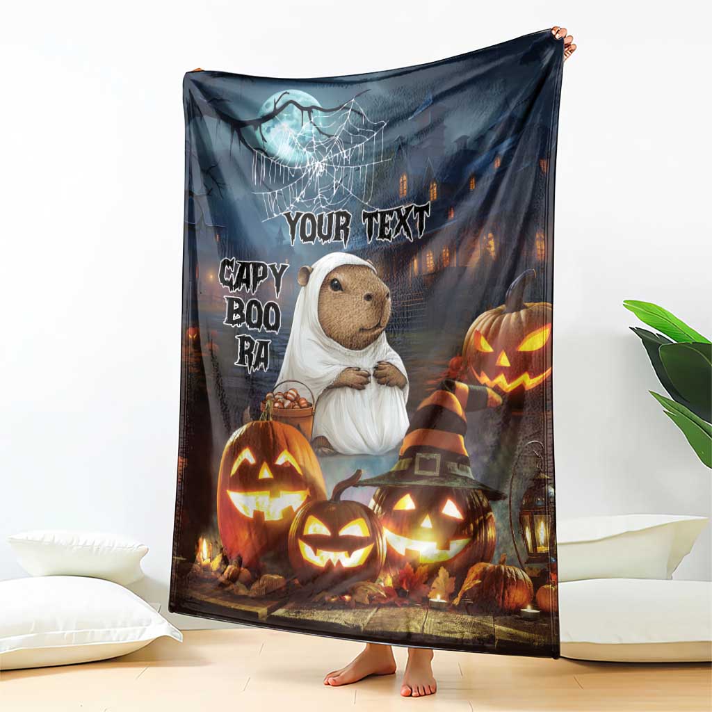 Halloween fleece blanket featuring a capybara in a ghost outfit and carved pumpkins with text