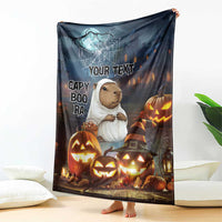 Halloween fleece blanket featuring a capybara in a ghost outfit and carved pumpkins with text