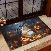 Halloween rubber doormat at doorway, capybara ghost, carved pumpkins, spiderweb and lanterns.