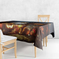 Halloween tablecloth draped over table with spooky pumpkins, lanterns, and trees