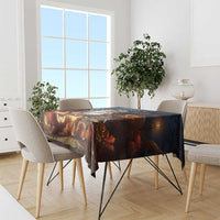 Halloween tablecloth on dining table with lanterns, fall leaves, and forest scene