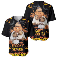 Two black baseball jerseys with capybara Halloween graphics, pumpkins, and bat accents