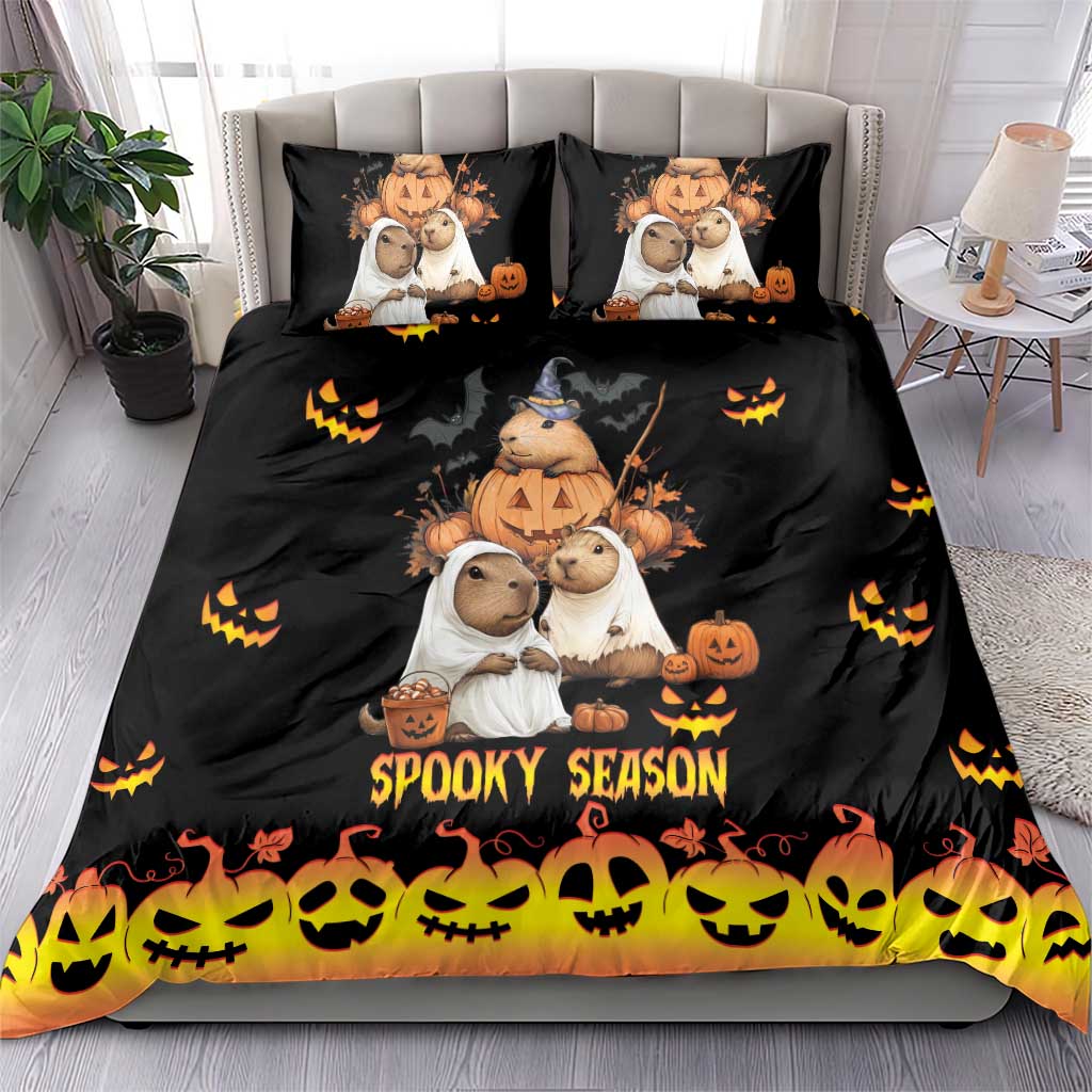 Black bedding set with capybara Halloween characters, pumpkins, and 'Spooky Season' on duvet and pillows
