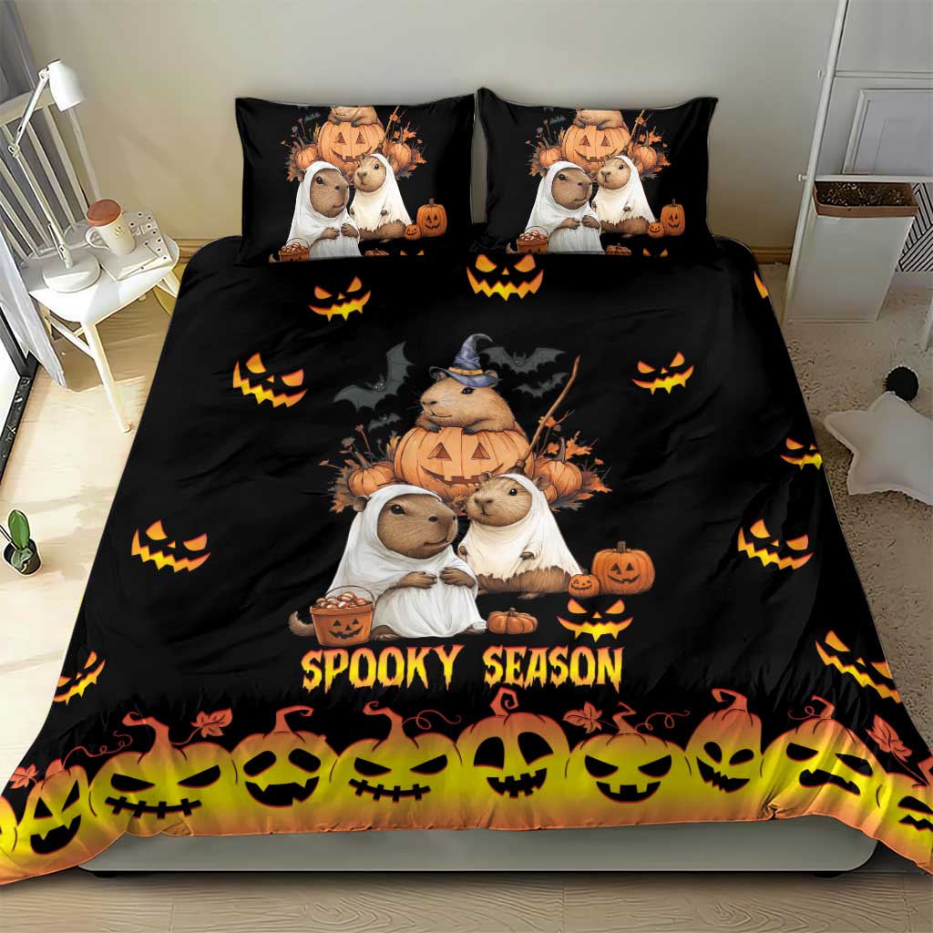Black bedding set with capybara Halloween characters, pumpkins, and 'Spooky Season' on duvet and pillows