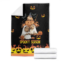 Spooky season blanket folded with white rolls, black and orange gradient “Spooky Season” design