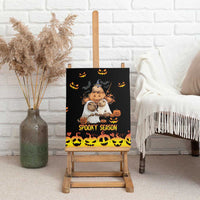 Spooky black canvas wall art on a wooden easel, with pumpkins and animals