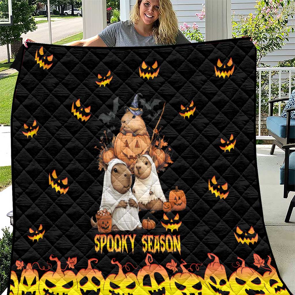 Black quilt with quilted diamond pattern, orange jack-o-lanterns, and 'Spooky Season' print