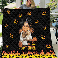 Black quilt with quilted diamond pattern, orange jack-o-lanterns, and 'Spooky Season' print
