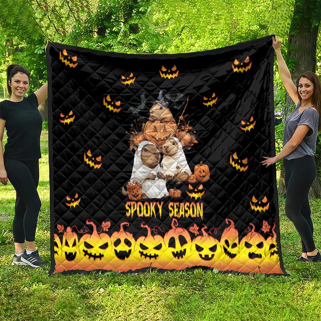 Black quilt with quilted diamonds, orange jack-o-lantern icons, 'Spooky Season' at the bottom