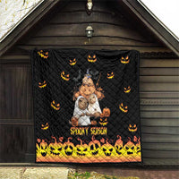 Black quilt hanging indoors with jack-o-lantern pattern and 'Spooky Season' border